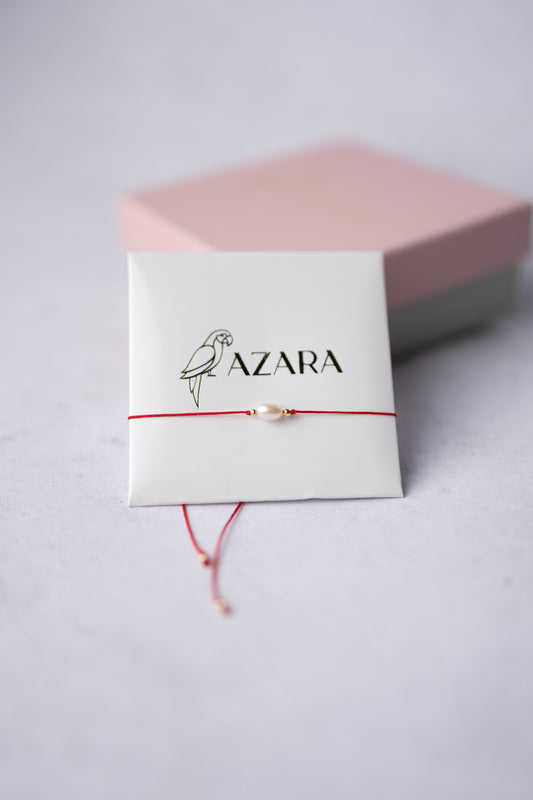 Bransoletka perła na czerwonej nitce